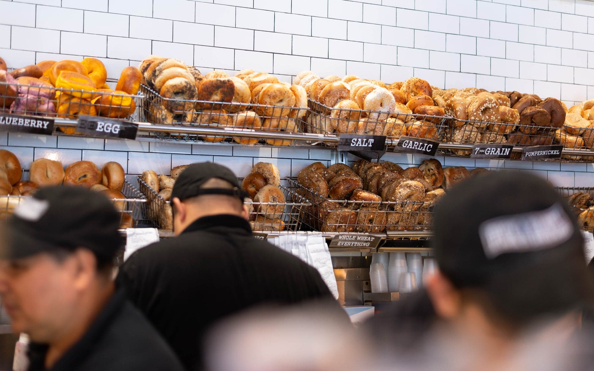 Shelves of fresh bagels behind the All Star counter